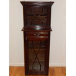 An Edwardian mahogany two tier cabinet, with astragal glazed doors enclosing shelves, W.