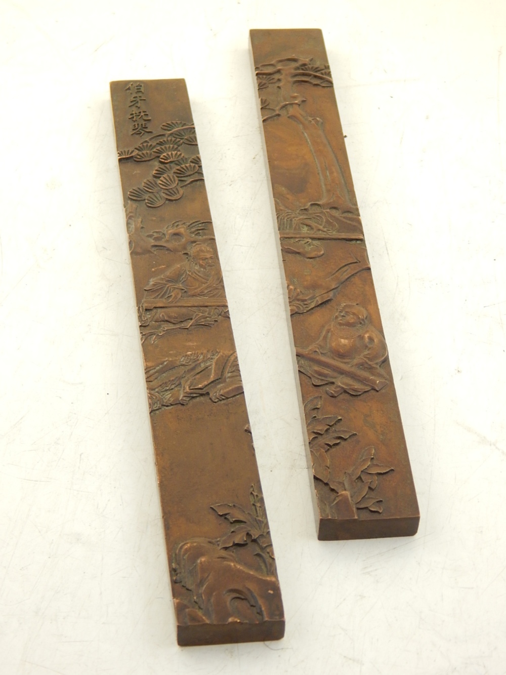 A pair of Chinese bronze calligraphy weights, cast with seated figures in a blossom landscape. H. - Image 2 of 3