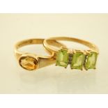 A 9ct yellow gold three stone emerald cut peridot ring,