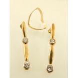 A 9ct yellow gold wishbone ring together with a pair of 9ct white stone pendant ear studs.