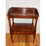 A George III mahogany two tier washstand, with a three quarter gallery,