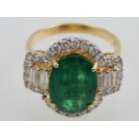 An 18ct yellow gold, emerald and diamond dress ring, the oval cut emerald of approx. 4.