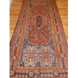 A red ground Qashqai runner, decorated with traditional stylised floral design, fringed.