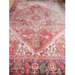 A brick red ground Heriz carpet,