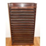 An early 20th century mahogany map or architects cabinet with 3/4 gallery over 15 open divisions on