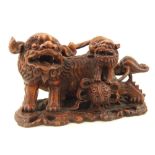 An Oriental study of a large temple lion Shishi dog, with smaller dog and puzzle ball. W.