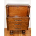 An Art Deco oak bureau, the fall front over three drawers on ball and block feet. W. 76cm x H.