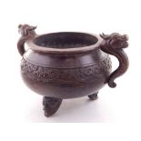 A Chinese bronze censor, of squat circular form with cast dragon twin handles,