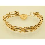 A 9ct yellow gold gate link bracelet, with heart lock, 7.