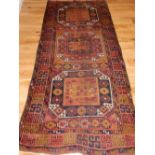 A Pakistani rug, decorated with stylised floral design on a geometric design, fringed, L.