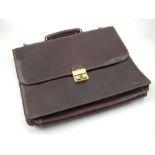 Tony Perotti, a gentleman's brown leather briefcase.
