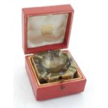 A Cartier pyrite ashtray, square with canted corners and set with cabochon sapphires,