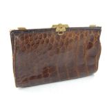 A brown ladies croc handbag clutch.