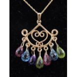 A 9ct yellow gold multi gem drop pendant, suspended on a 9ct yellow gold chain.