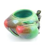 A Chinese green and red glazed ceramic dish, fashioned as peaches on a branch,