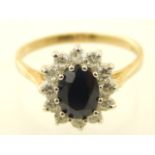 A 9ct yellow gold blue and white stone dress ring, with central oval faceted stone.