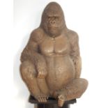 A large cast figure of a gorilla, seated. H.
