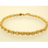 A 9ct yellow gold and white stone line bracelet,