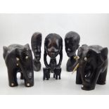 Seven West African hardwood carvings, depicting female busts and elephants.