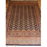 A machine made Bokhara style blue ground rug, 237 x 160cm, together with a Keshan machine made rug.