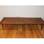 A provincial iron bound low occasional table, with planked top on splayed feet,