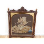 A late Victorian tapestry fire screen panel, showing a hunter on horse-back lancing a lion,