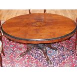 A Victorian inlaid walnut loo table the oval tilt top on carved quadruple cabriole base. W.