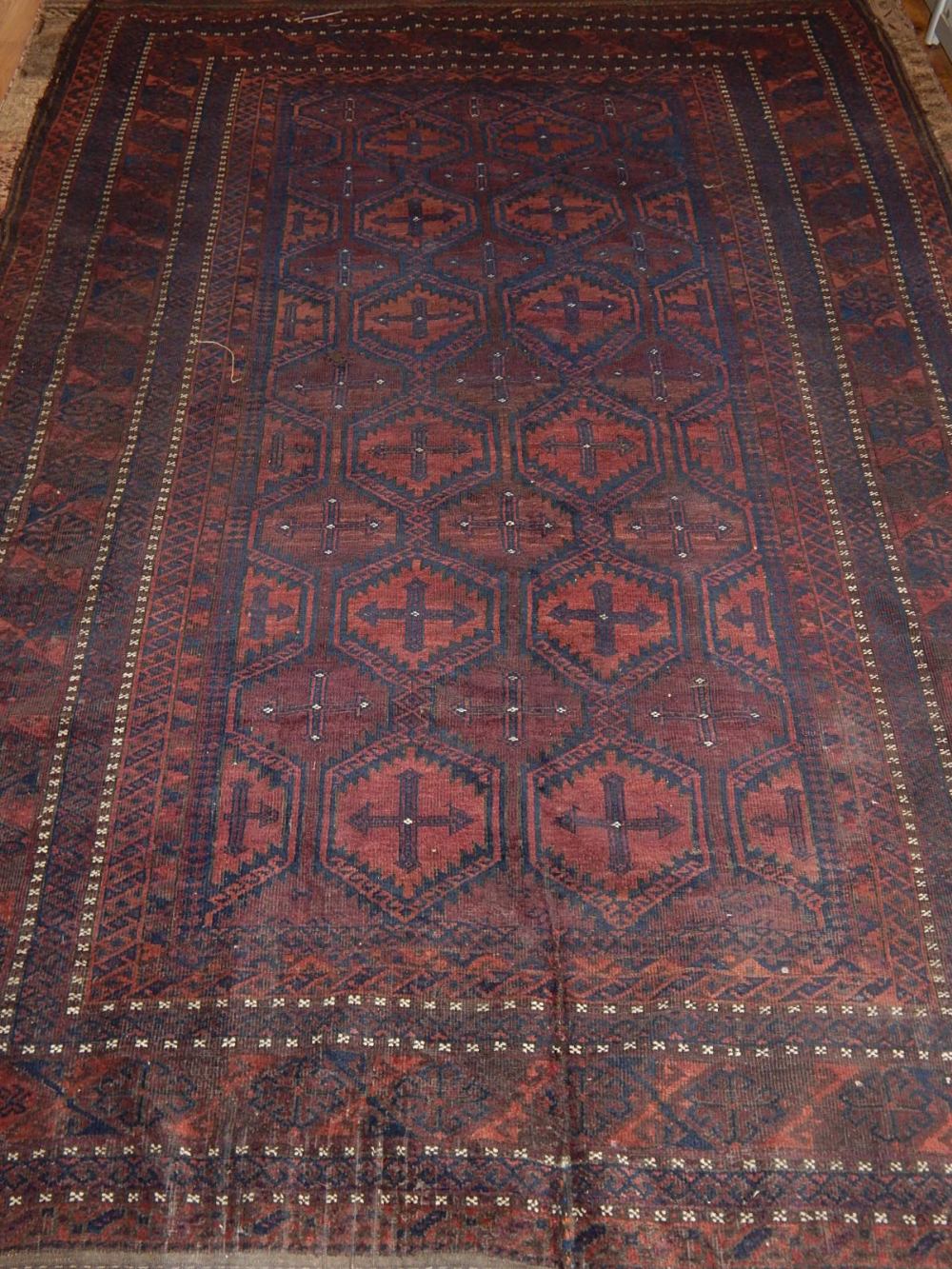 A Baluch carpet, decorated with octagonal medallions to centre within reticulated borders, fringed. - Image 3 of 3