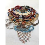 A quantity of costume jewellery, to include bone necklaces, a filigree white metal bangle,