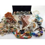 A large quantity of assorted costume jewellery, to include paste brooches and dress rings,