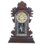 A late 19th century Ansonia mantel clock, the fretwork arched case with a glazed panel. H.