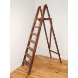 A pair of mid 20th century wooden six tread stepladders, (1).