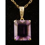 A 9ct yellow gold, emerald cut amethyst and diamond pendant, suspended on a 9ct gold chain.