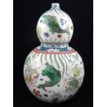 A Chinese porcelain double gourd vase, decorated with carp and lily pads,