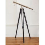 A chrome plated telescope, raised on an ebonised tripod, 149cm.