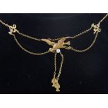 An Edwardian yellow metal drop pendant necklace, fashioned with pearl set bird catching fish.