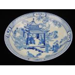 A Chinese blue and white dish, decorated with figures in landscape, bears seal mark to base, diam.