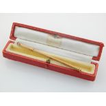 A 9ct gold Cartier swizzle stick, with box, 6g.