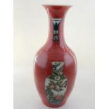 A Chinese red ground baluster vase with everted rim, decorated with vases, bears character mark to