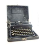 An early 20th century HMV portable wind up gramaphone together with a vintage Royal typewriter.