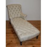 A 19th century daybed upholstered in deep buttoned silver / ivory fabric on turned tapered legs, L.