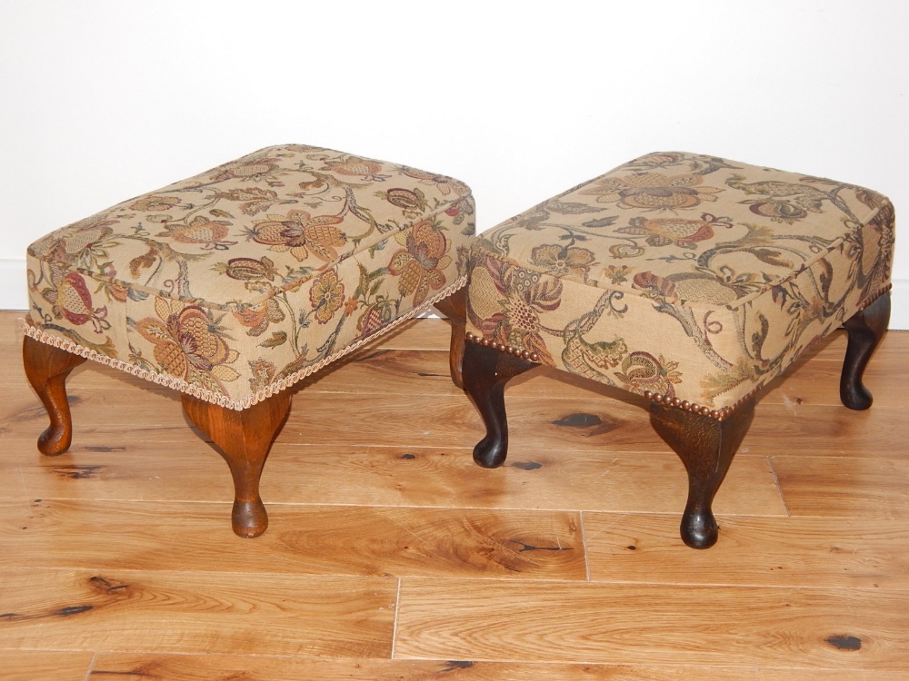 A pair of 20th century rectangular foot stools, covered on foliate fabric and on short cabriole