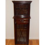 An Edwardian mahogany two tier cabinet, with astragal glazed doors enclosing shelves, W. 56cm