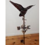 A beaten copper weather vane modelled as a goose in flight over directional arrow on chromed ball