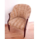 A 19th century mahogany framed tub chair, covered in a leopard skin style fabric, on moulded tapered