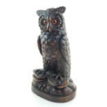 A Black Forrest carved owl, with hinged top. H.31cm