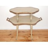 A two tier occasional table, the shaped oval tiers with a pair of carrying handles, on moulded legs,