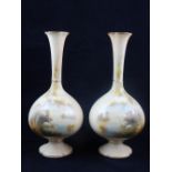 A pair of early 20th century Worcester blush glazed vases, of globe form with extended narrow necks,