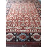 A Turkish red ground rug, seriated foliate pattern on a red ground within a black border, 281 x