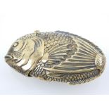 A brass vesta case in the form of a fish.